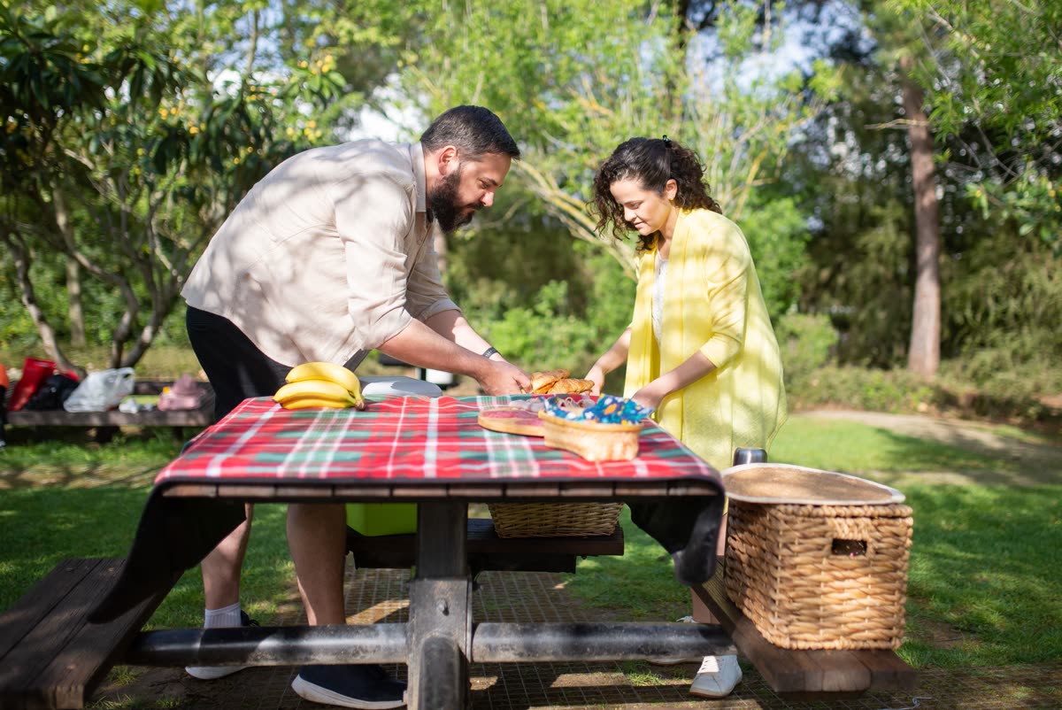A family sharing food and refreshments together outdoors