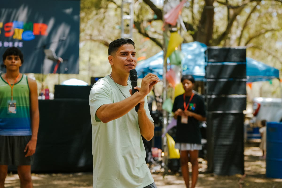 A guest speaker addressing the crowd with a microphone